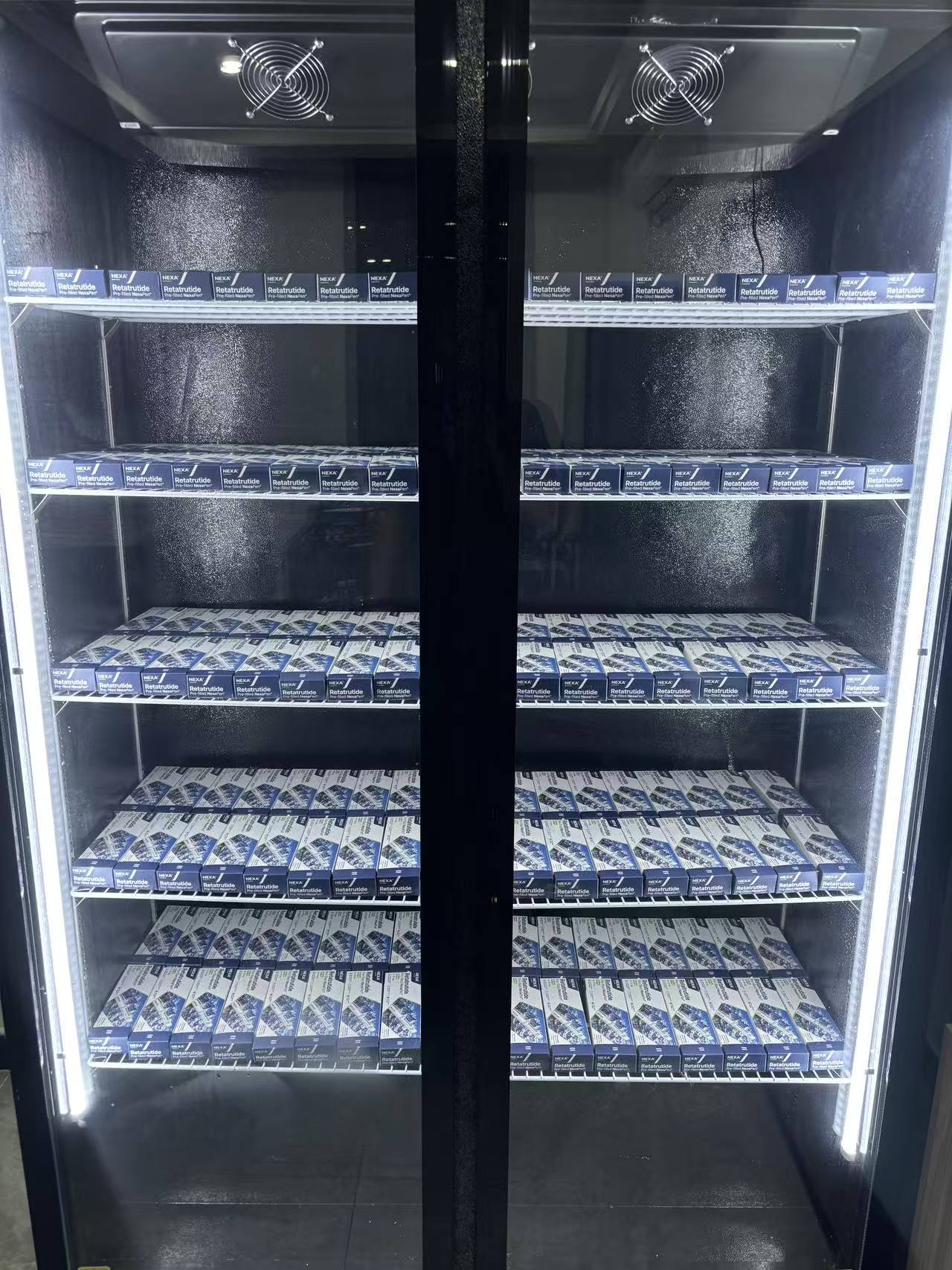 NEXA product boxes arranged on shelves in a storage cabinet